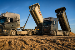 two_trucks_at_site_rollover_up